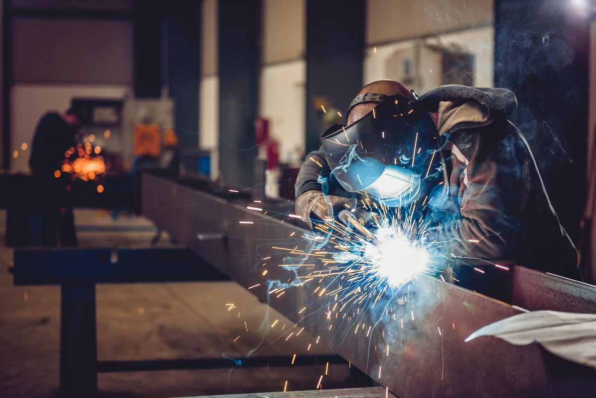 Welder fabricating a structural steel beam